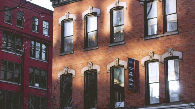Red brick multi-unit building with tall windows, typical of Chicago two-flats and small rentals