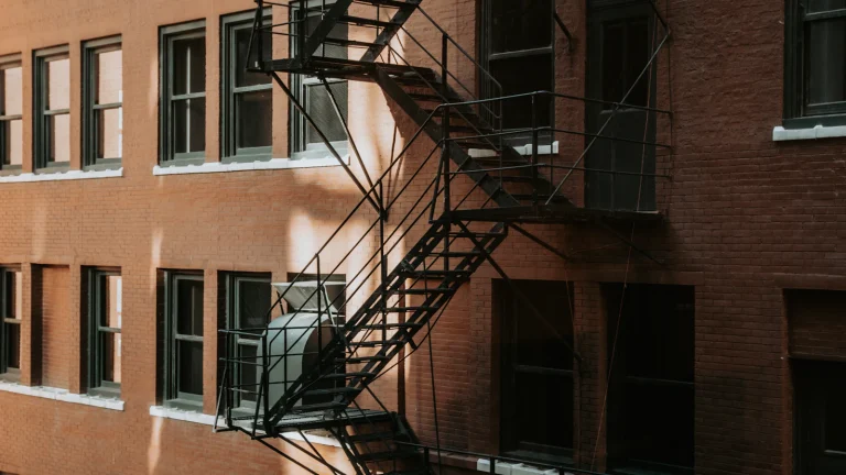 Brick apartment building with a metal fire escape, illustrating building code violations in Chicago
