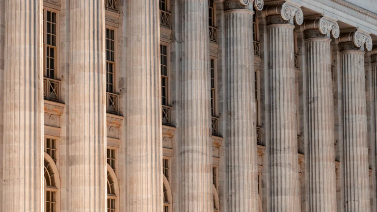 Stone columns of a courthouse, where a probate estate is opened before a house can be sold