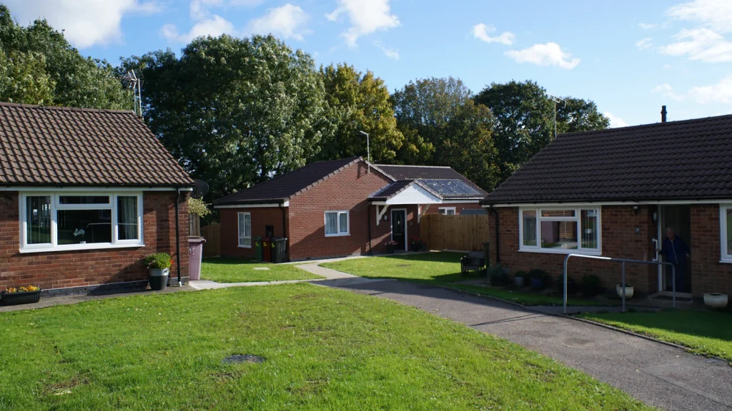Brick bungalows with green lawns on a suburban street, the kind of homes that need a point-of-sale inspection